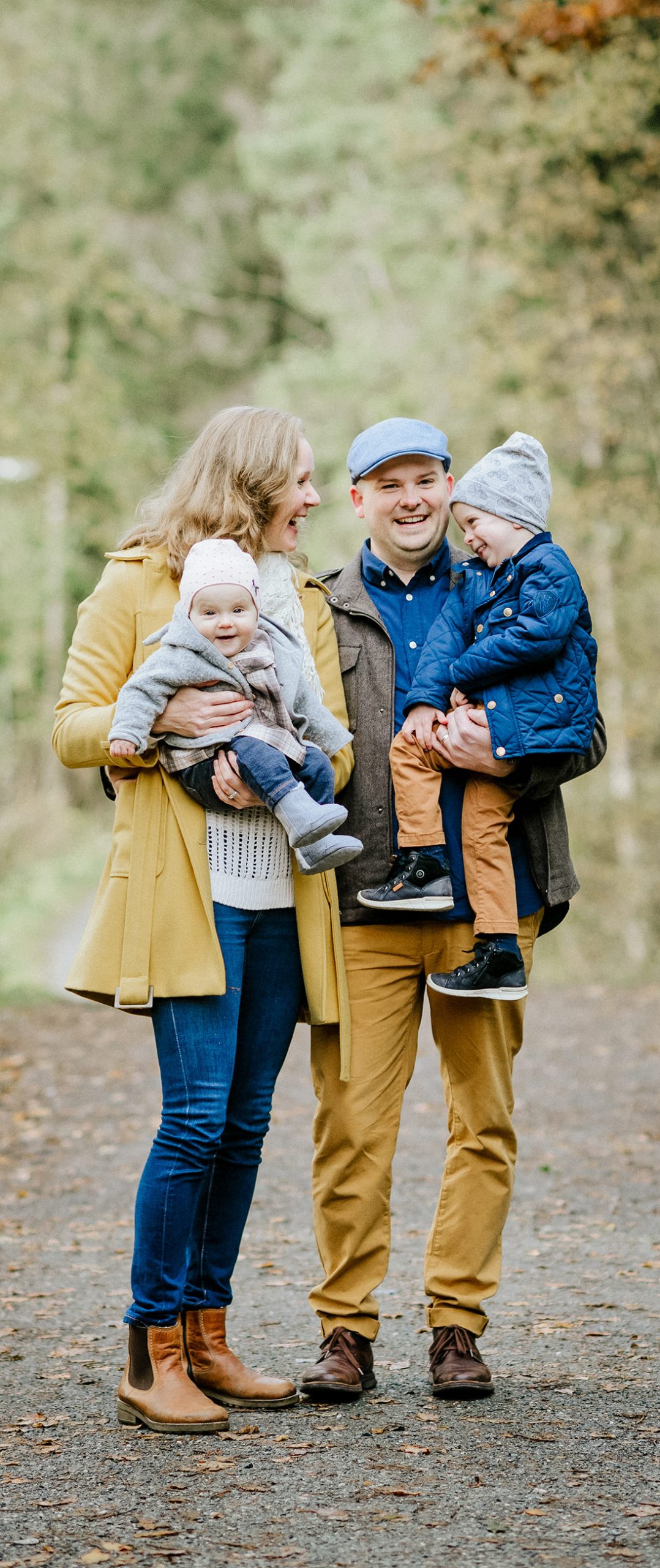 Travis D Peterson and family fall photo. Travis is holding Aiden, Anne Berit is holding Esther.